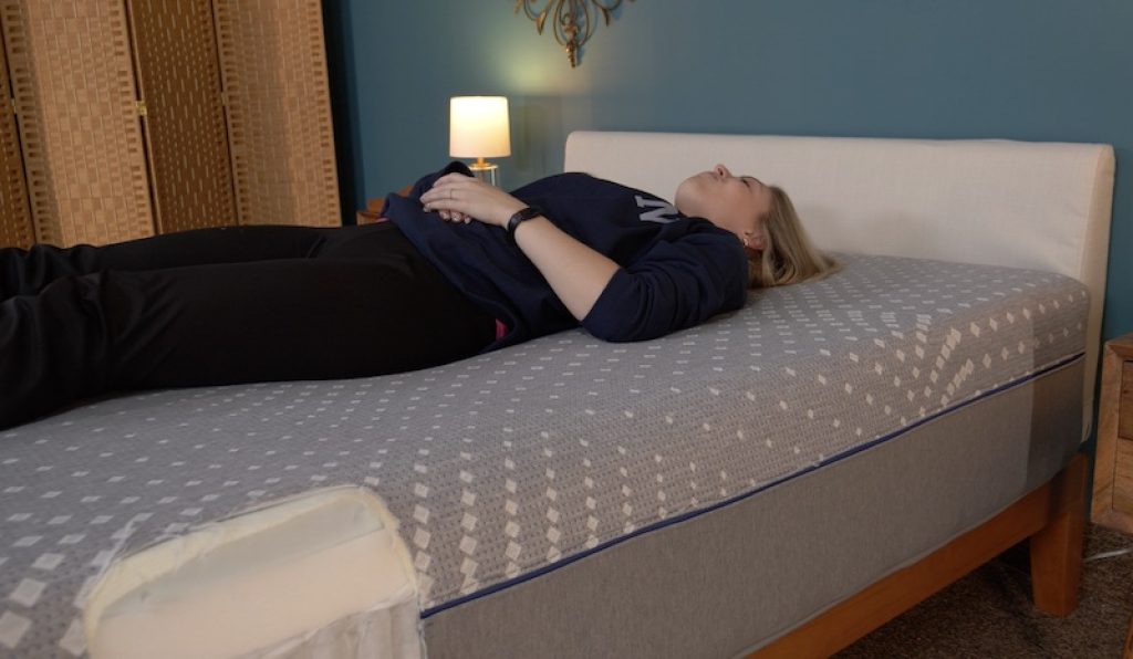Julia Forbes testing each mattress in a back sleepers position 