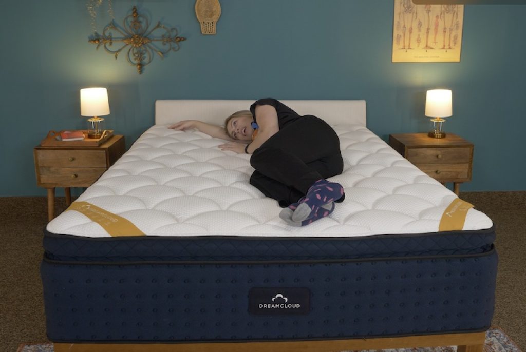 Julia Forbes testing a mattress for side sleeping