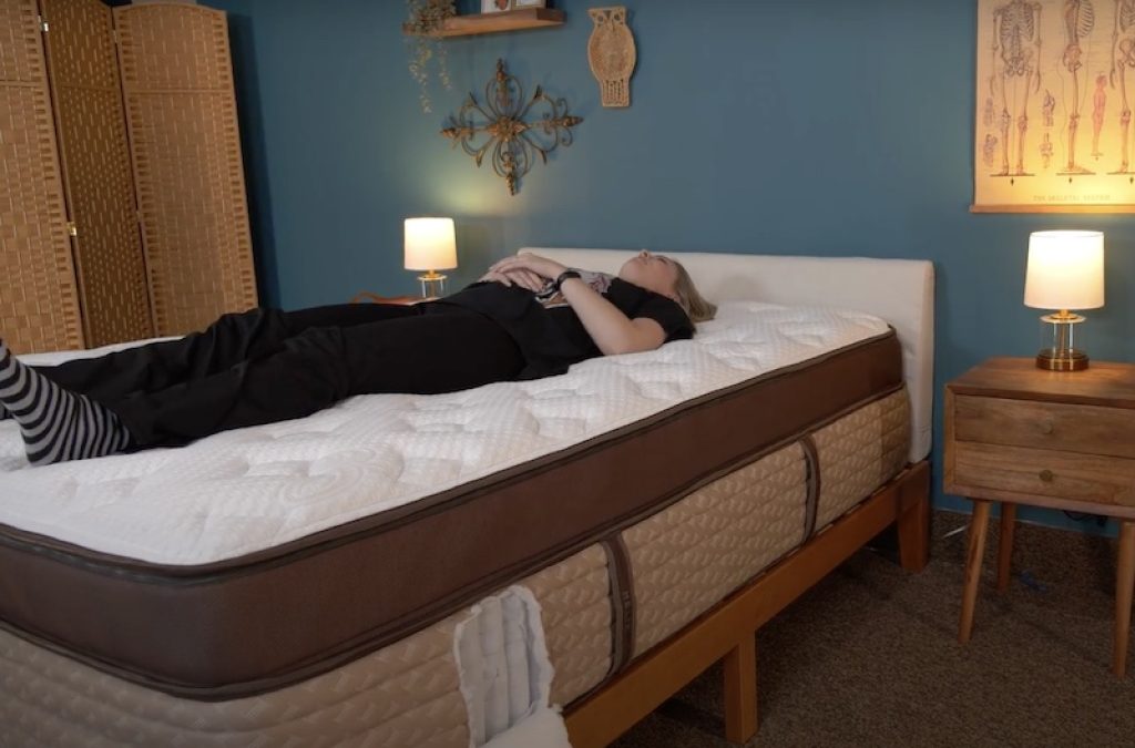 Julia Forbes testing a mattress in the back sleeper sleeping position